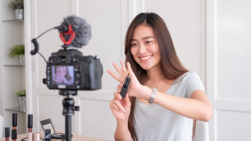 photo of young woman using video marketing to promote her products