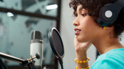 image of woman recording with a microphone