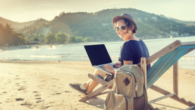 photo of blogger working on beach with laptop