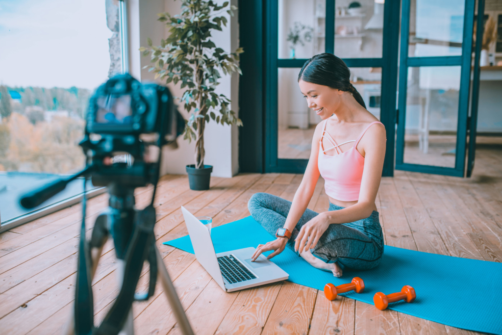 photo of a fitness blogger filming an exercise video