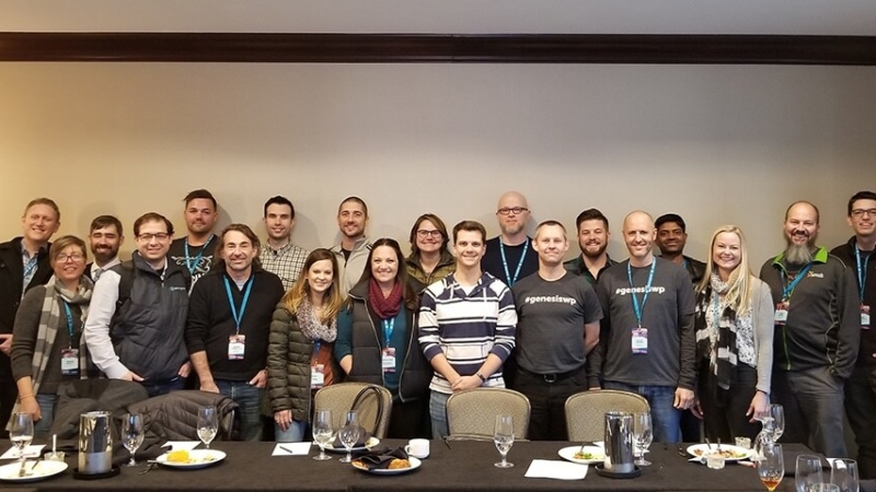 Genesis shapers group standing at table