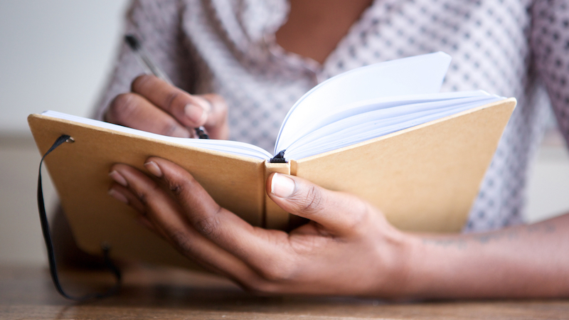 Woman writing in notebook