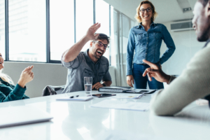 Businessman offering high five to a coworker during a meeting