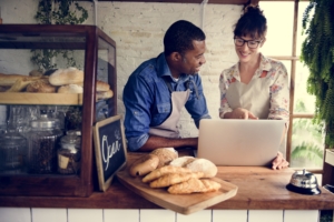 partners of small business bakery working on a laptop together