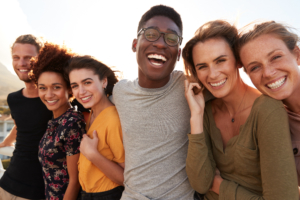 Portrait Of Smiling Young Friends Outdoors Together