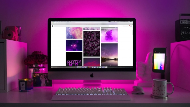 computer with pink florescent light glowing around it