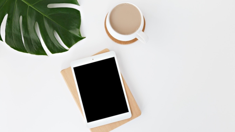 tablet, coffee, leaf on minimal white background