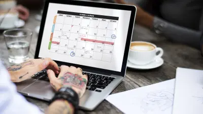 photo of man checking his content calendar on laptop