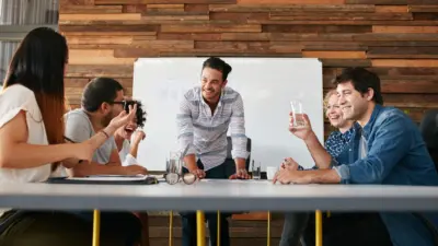 group of people at an agency sitting down at a table talking