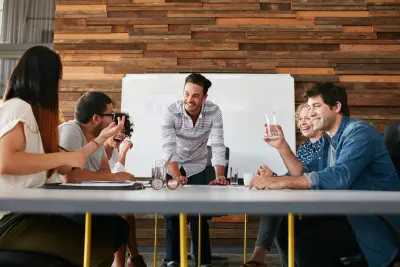 group of people at an agency sitting down at a table talking