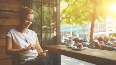 Woman sitting in cafe on phone