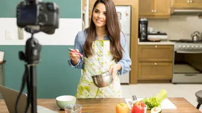 photo of a female food blogger making a recipe and taking a video