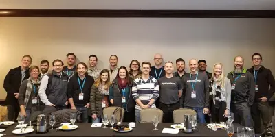 Genesis shapers group standing at table