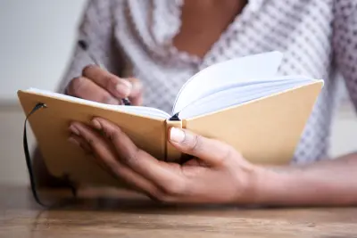 Woman writing in notebook