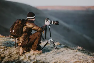 photographer taking landscape photo on mountain
