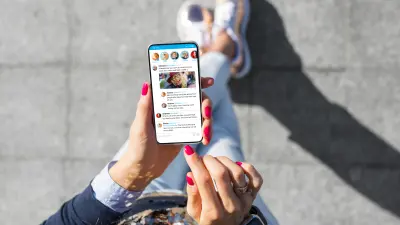 Woman Using Social Media Microblogging App On Her Phone