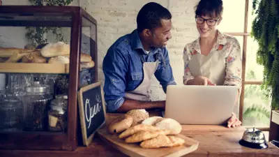 partners of small business bakery working on a laptop together