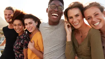 Portrait Of Smiling Young Friends Outdoors Together