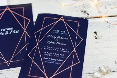 wedding invitation card on white wooden surface