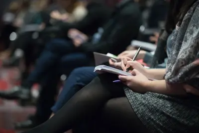 people taking notes at an event