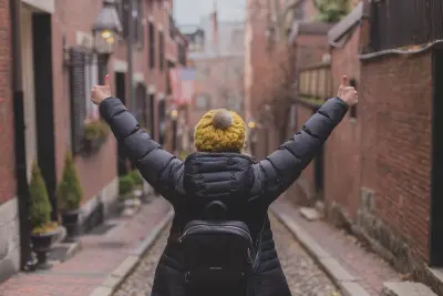 view from behind of woman giving two thumbs up 