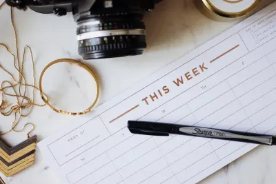 closeup photo of ballpoint pen near camera, wedding planning concept