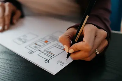 UX Work: Woman's hands drawing a wireframe