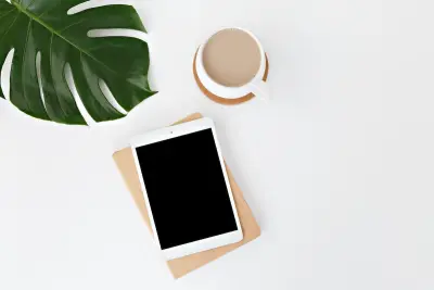 tablet, coffee, leaf on minimal white background