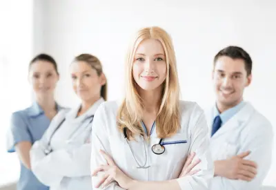 attractive female doctor in front of medical group