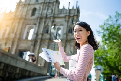 Woman holding city travel guide in Macao city